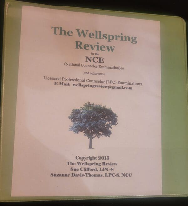 A green folder with the cover of the wellspring review.